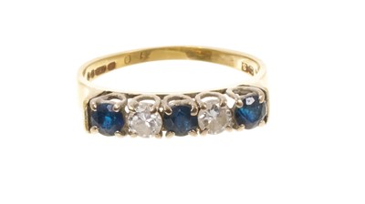 Lot 410 - Sapphire and diamond five stone ring with three round mixed cut blue sapphires and two brilliant cut diamonds in claw setting on 18ct gold shank, London 1977.