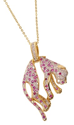 Lot 406 - Ruby and diamond pendant in the form of a Panther, with pavé set diamonds and mixed cut rubies, in a gold trace chain