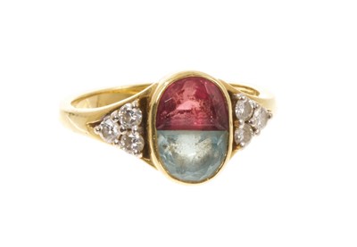 Lot 411 - Diamond, aquamarine and pink tourmaline dress ring with two opposing stones in oval rub-over setting flanked by brilliant cut diamonds to the shoulders, on 18ct gold shank, London 1994.