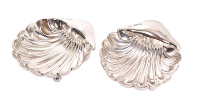 Lot 276 - Pair of Edwardian silver shell shaped dishes, raised on three ball feet, (Sheffield 1905), maker Aitken Brothers, each 9.5cm in length, all at 2.6ozs.