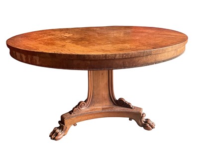 Lot 1291 - George IV rosewood breakfast table, the circular top with beaded edge on carved triform column and triangular base on paw feet