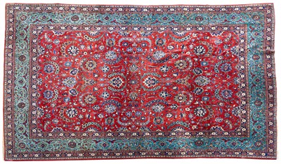 Lot Fine kurk Kashan carpet, Central Persia, c.1910, deep terracotta field with overall scrolling curvilinear vines issuing polychrome palmettes, flower heads and leaves, within a green palmette and...