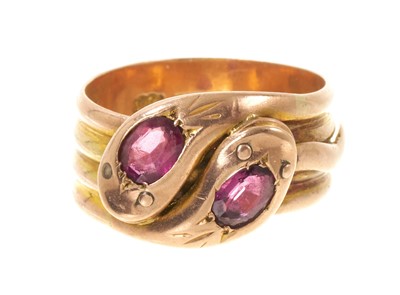 Lot 421 - Edwardian 9ct rose gold double snake ring, the two interlocking snakes with oval mixed-cut garnets to the heads, Birmingham 1910, ring size approximately U.