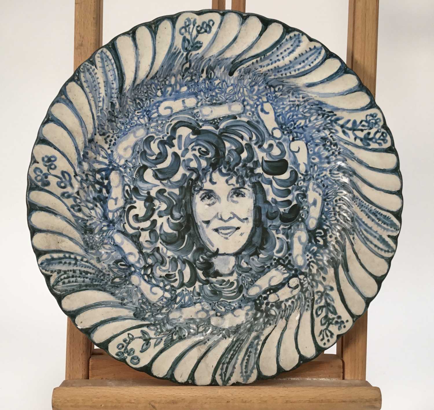 Lot 944 - *Mary Millar Watt (1924-2023) hand painted ceramic plate decorated with a portrait of Anita Roddick, signed and titled verso, 30.5cm diameter