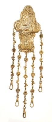 Lot 471 - Late 19th century gilt metal chatelaine with figural reserves and rococo cartouches, suspending five articulated floral scroll chains, 21cm.