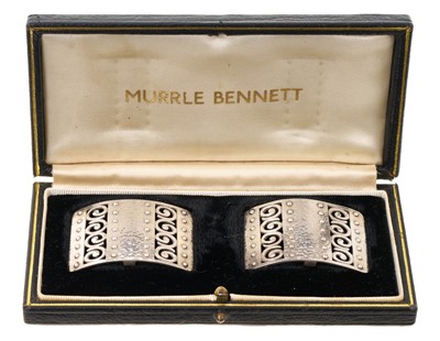 Lot Pair of Murrle Bennett silver (850 standard) buckles with pierced scrolls, riveted and hammered finish, maker's marks, stamped 850, in original gilt tooled black leather box. The buckles 31mm x...