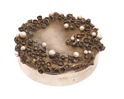 Lot 201 - Jocelyn Burton (1946 - 2020), fine contemporary silver trinket box of circular form, the flush fitting top with simulated barnacle decoration, set with pearls opening to reveal a gilded interior...