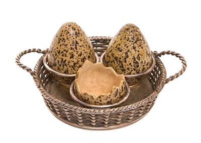 Lot 225 - Early 20th century novelty three piece cruet set by Macintyre & Co in the form of birds eggs, each marked to base Rd. No. 10586 / 10587 in a silver plated stand in the form of a basket, with...