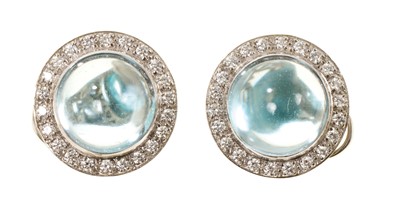 Lot 451 - Pair of good quality blue topaz and diamond cluster earrings, each with an aquamarine cabochon measuring approximately 13mm diameter surrounded by a border of brilliant cut diamonds, in white go...