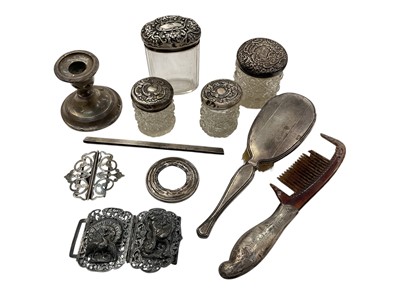 Lot 971 - Group of silver mounted glass vanity jars, silver back dressing table brush and comb, silver candlestick, silver buckle, one other Eastern buckle etc