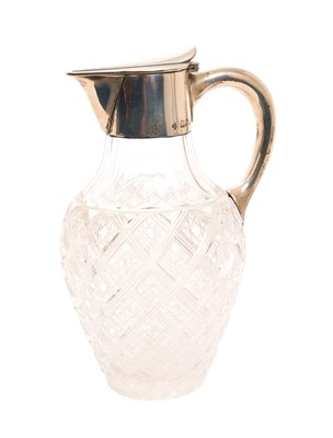 Lot 233 - Victorian cut glass and silver claret jug with facet cut neck and star cut body and base, the silver mount with hinged cover and loop handle, (London 1898), maker Horace Woodward & Co Ltd, 1...
