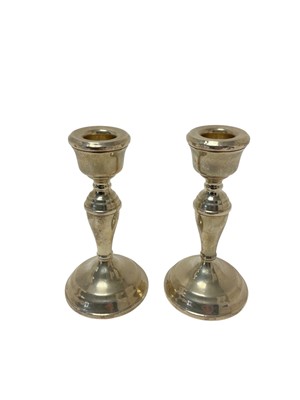 Lot 236 - Pair of contemporary silver candlesticks, with tapered central columns and domed circular bases, (Birmingham 1984), maker Broadway & Co, each 13.5cm in overall height, (2).