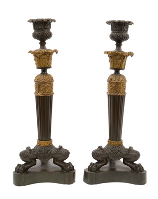 Lot 921 - Pair of Regency bronze and ormolu candlesticks with lion paw feet
