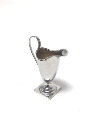 Lot 297 - Victorian silver helmet shaped cream jug of small proportions, on square pedestal base, (Birmingham 1898), maker George Unite, 12cm, 3oz.
