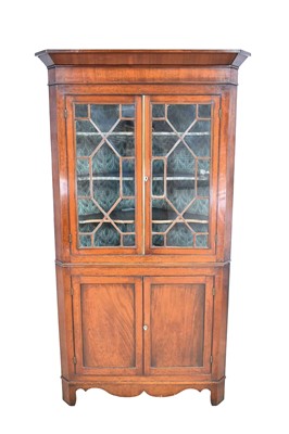 Lot 1240 - George III flame mahogany corner cupboard