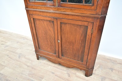 Lot 1240 - George III flame mahogany corner cupboard