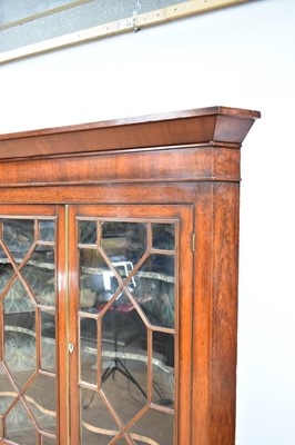 Lot 1240 - George III flame mahogany corner cupboard