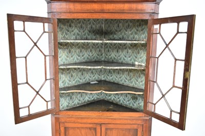 Lot 1240 - George III flame mahogany corner cupboard