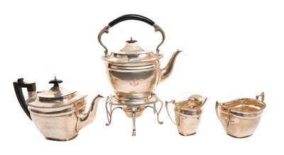 Lot 289 - George V silver four piece tea set comprising a tea kettle on stand with burner, tea pot, sugar basin and milk jug, all with gadrooned edge and engraved family crest, (London 1914)