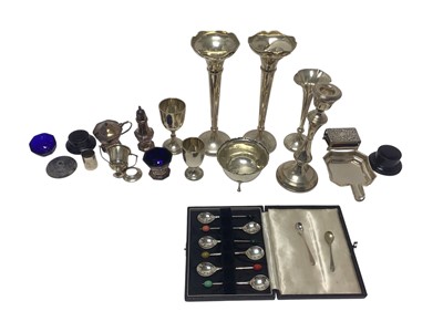 Lot 318 - Group of silver items to include a pair of George V silver spill vases, (Birmingham 1918), six silver coffee spoons in a fitted case, cruet set and other items, (various dates and makers), 15.5o...