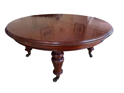 Lot 1335 - Fine Victorian mahogany extending dining table, the metamorphic sliding mechanism starting at four quarter segments creating a circle, measuring 164cm diameter. With an arrangement of four small...