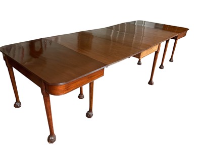 Lot 1360 - George III Irish mahogany extending dining table, with twin D-ends and central drop-leaf section, raised on turned legs and hairy paw feet, total dimensions 308 x 115cm