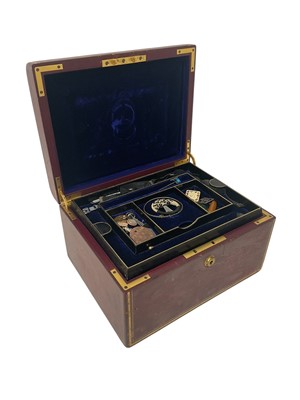 Lot 700 - Victorian red leather jewellery box with navy blue velvet interior and two removable trays containing a small group of antique and vintage jewellery and bijouterie