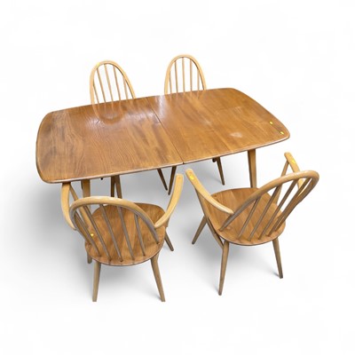 Lot 5299 - Ercol extending dining table and eight chairs