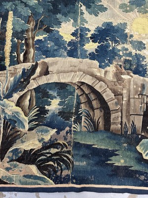 Lot 1502 - Flemish, late 17th / early 18th century Verdure tapestry depicting a sunrise over a bridge Provenance: Joanna Booth, Kings Road, London, 29th September 1990