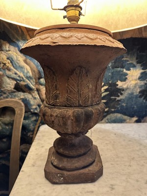 Lot 1509 - Pair of terracotta campana shape urns with stiff leaf and lobed decoration on chamfered square bases, now as table lamps