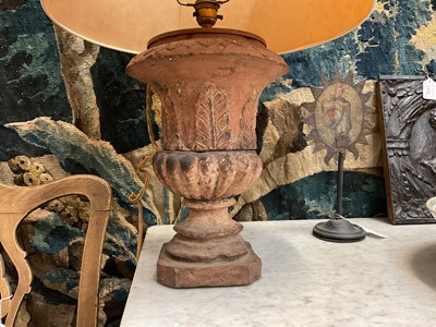 Lot 1509 - Pair of terracotta campana shape urns with stiff leaf and lobed decoration on chamfered square bases, now as table lamps