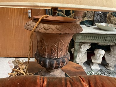 Lot 1509 - Pair of terracotta campana shape urns with stiff leaf and lobed decoration on chamfered square bases, now as table lamps