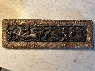 Lot 1510 - Antique, probably 17th century, carved oak frieze, depicting putto and mythical creatures, presented in a gilt and painted moulded frame, 15.5cm x 47.5cm