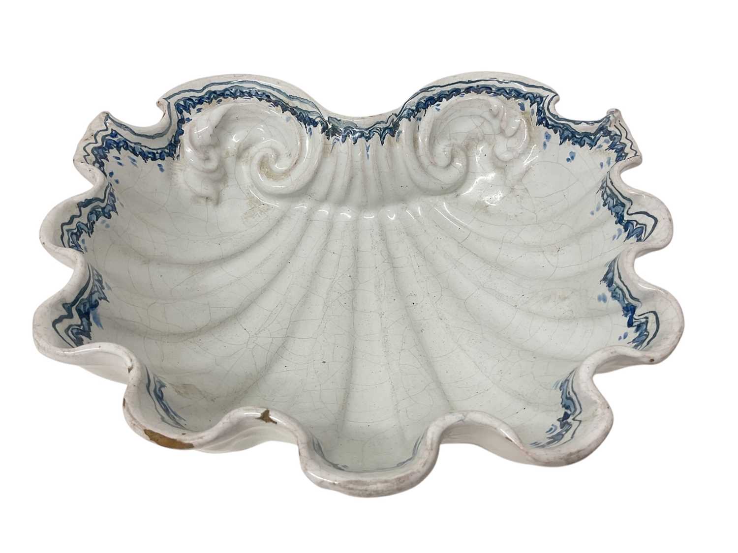 Lot 1525 - Large antique tin glazed scallop shell bowl