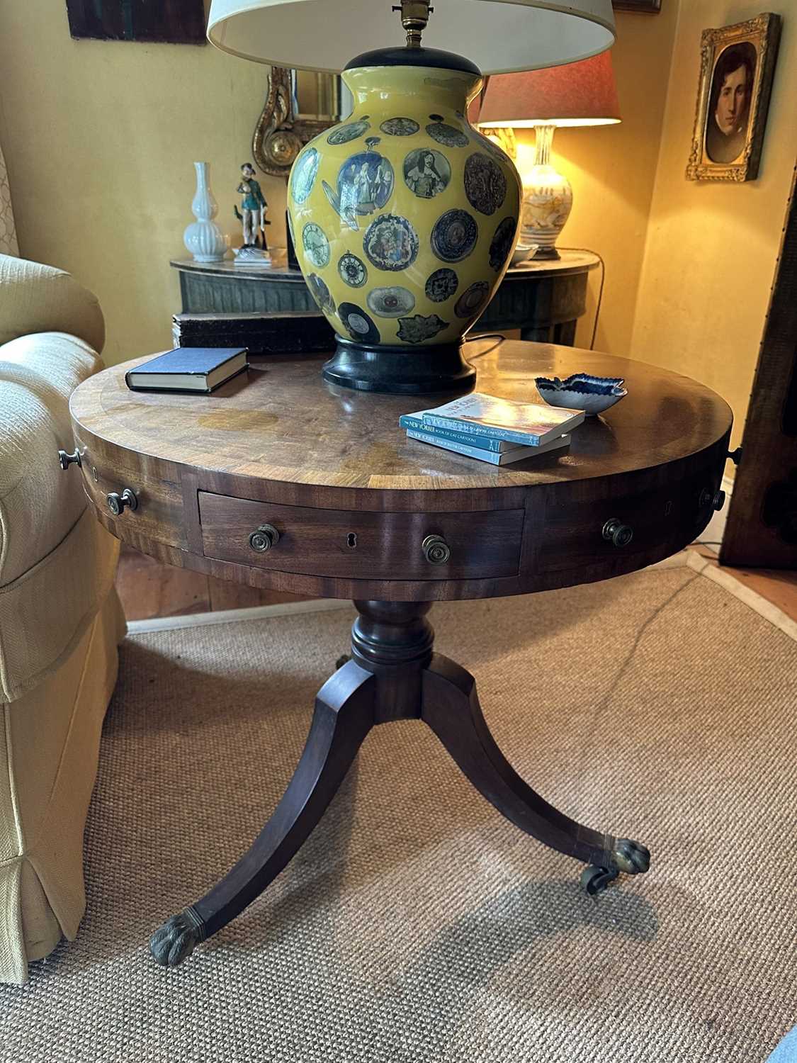 Lot 1529 - 19th century mahogany drum table with crossbanded top and an arrangement of drawers, on turned column and three splayed legs terminating on brass paw castors