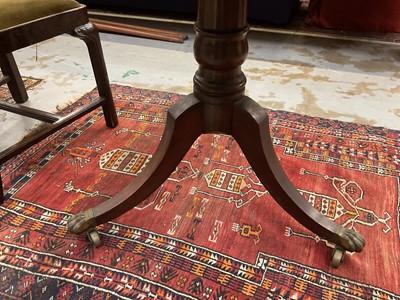 Lot 1529 - 19th century mahogany drum table with crossbanded top and an arrangement of drawers, on turned column and three splayed legs terminating on brass paw castors