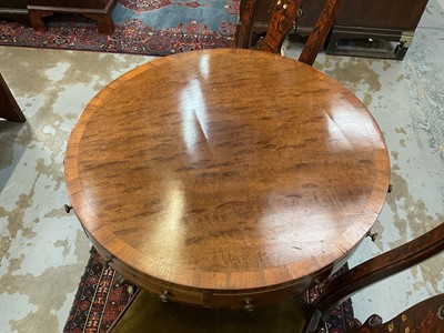 Lot 1529 - 19th century mahogany drum table with crossbanded top and an arrangement of drawers, on turned column and three splayed legs terminating on brass paw castors