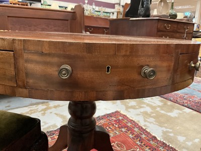 Lot 1529 - 19th century mahogany drum table with crossbanded top and an arrangement of drawers, on turned column and three splayed legs terminating on brass paw castors