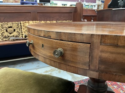 Lot 1529 - 19th century mahogany drum table with crossbanded top and an arrangement of drawers, on turned column and three splayed legs terminating on brass paw castors