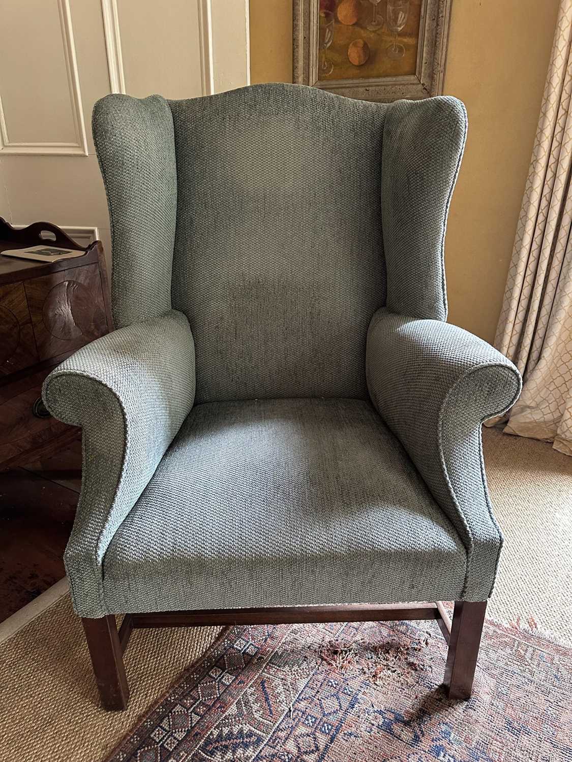 Lot 1532 - Georgian-style wing armchair upholstered in green fabric, on square legs