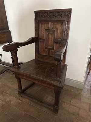 Lot 1637 - 17th century and later oak elbow chair, the panelled square back above a solid seat, turned supports joined by stretchers