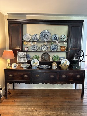 Lot 1638 - 18th century oak two height dresser, the central open shelves flanked by twin cupboards, three drawers below, on square legs