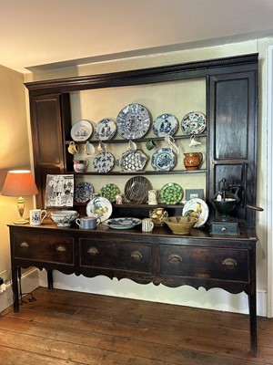 Lot 1638 - 18th century oak two height dresser, the central open shelves flanked by twin cupboards, three drawers below, on square legs