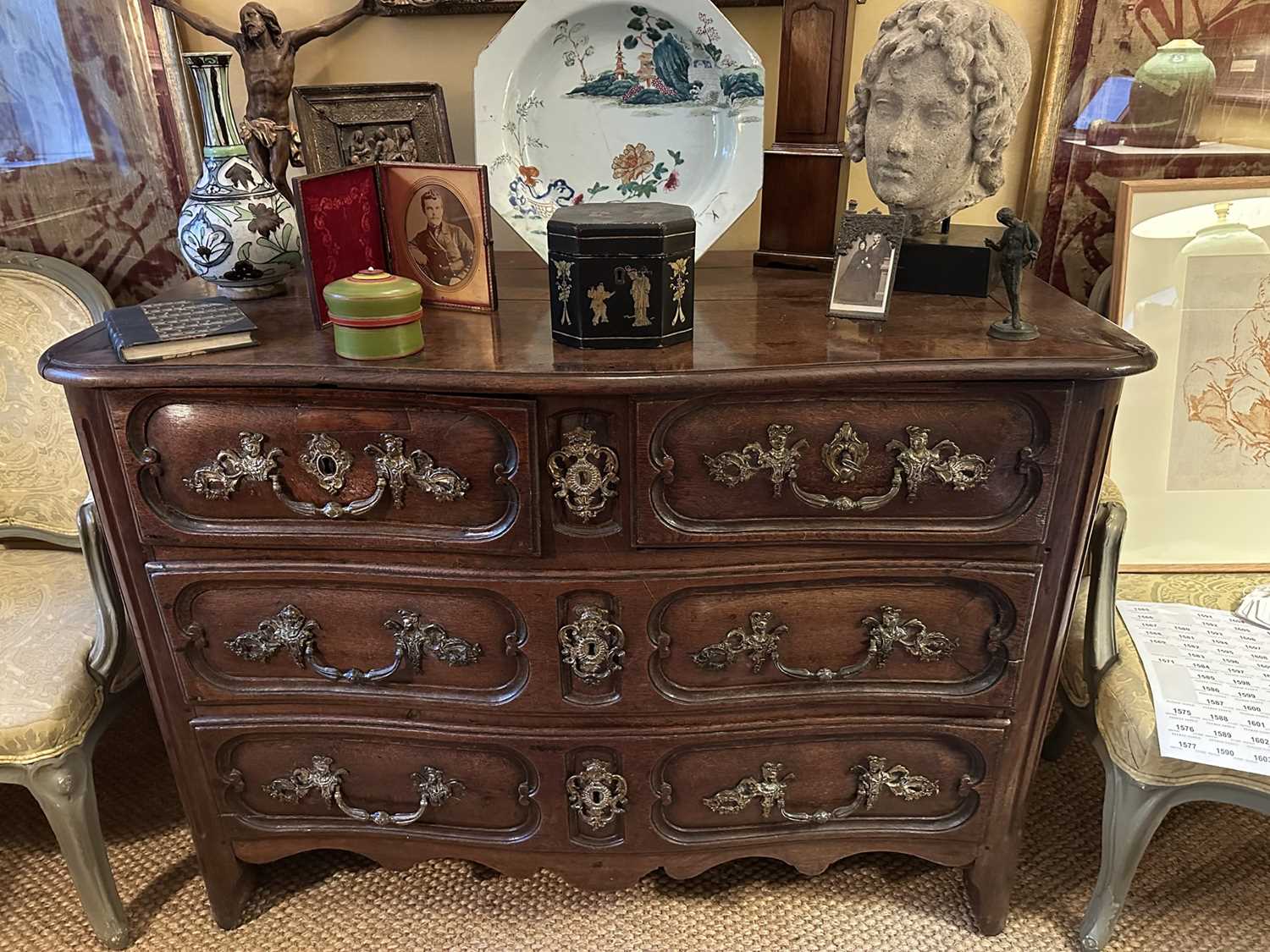 Lot 1558 - Early 18th century French oak serpentine chest of two short and two long drawers, with applied gilt brass mounts depicting figures and foliage