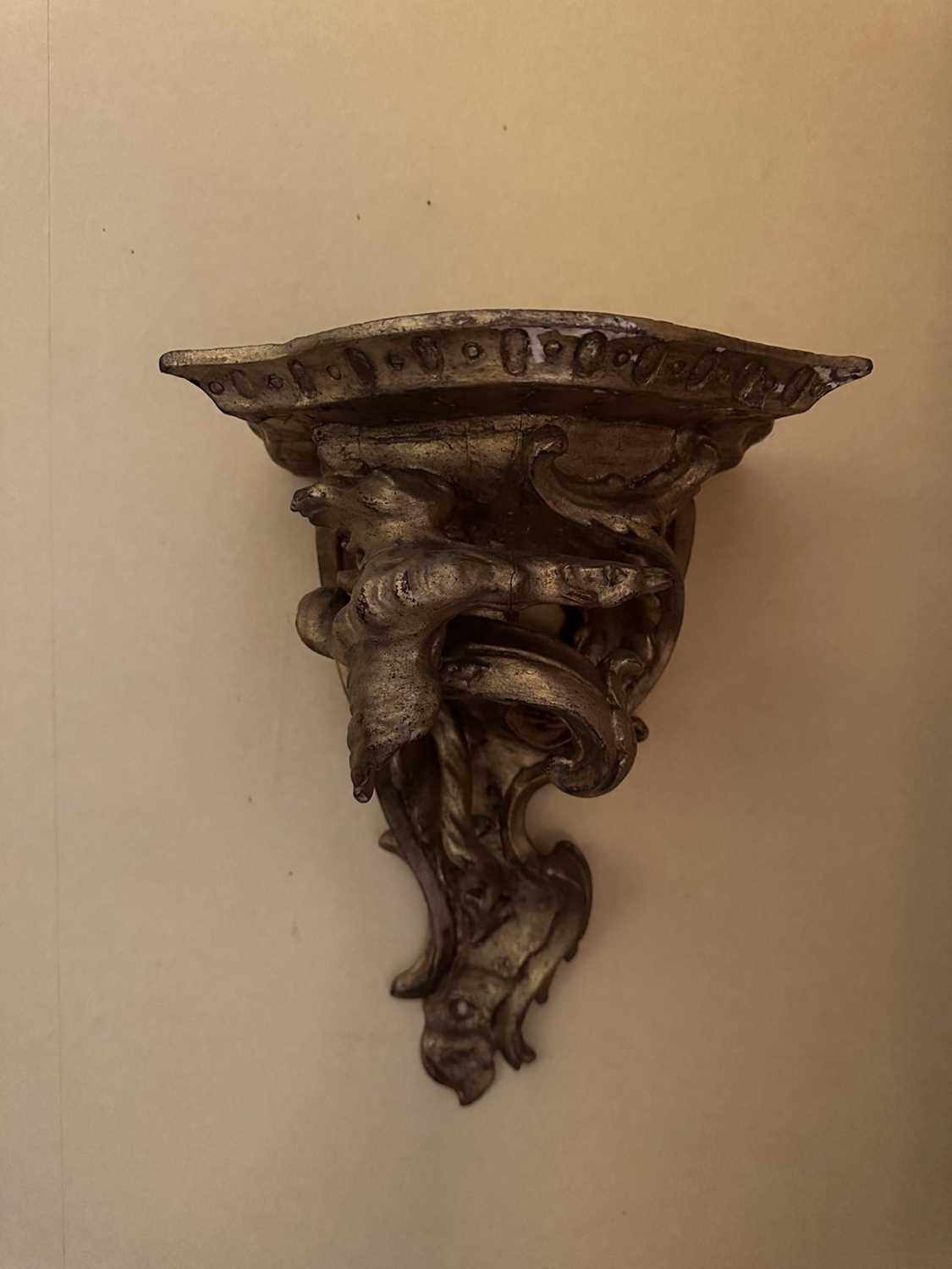 Lot 1567 - 18th century gilt bracket, the bowed platform above foliate scroll supports Provenance: Edward Hurst Antiques, Salisbury, 22nd June 1995