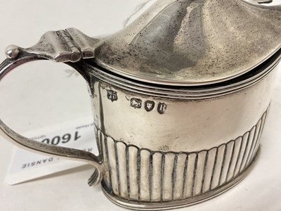 Lot 1600 - Victorian silver mustard pot with half reeded body and blue glass liner (London 1892), a Victorian Glasgow silver spoon and a pair of Georgian silver sugar tongs