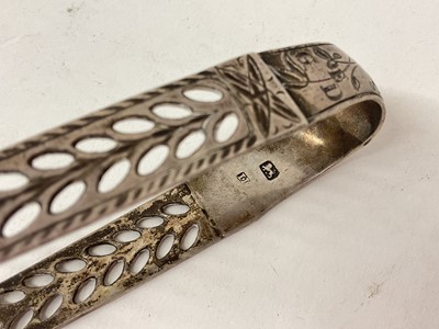 Lot 1600 - Victorian silver mustard pot with half reeded body and blue glass liner (London 1892), a Victorian Glasgow silver spoon and a pair of Georgian silver sugar tongs