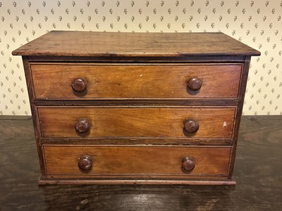 Lot 1676 - Late Victorian mahogany table top chest of three drawers with bun handles