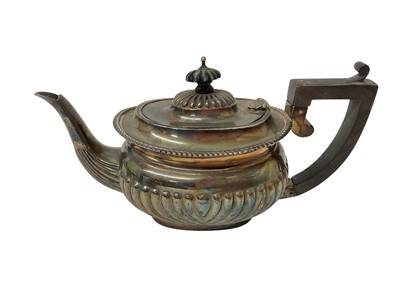 Lot 1602 - Edwardian silver teapot with half fluted body and gadrooned boarder, ebony handle and knop, (Birmingham 1902), all at 11ozs