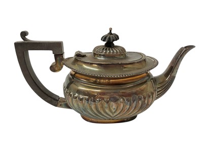 Lot 1602 - Edwardian silver teapot with half fluted body and gadrooned boarder, ebony handle and knop, (Birmingham 1902), all at 11ozs